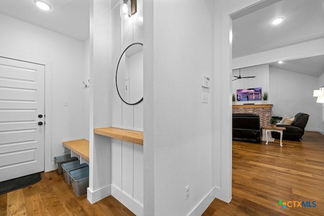 bathroom featuring hardwood / wood-style flooring and a fireplace