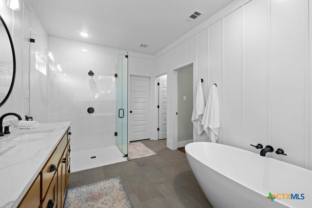 bathroom featuring vanity, independent shower and bath, and tile patterned flooring