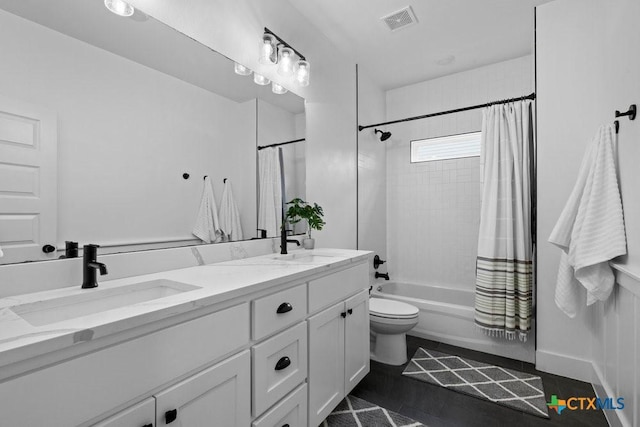 full bathroom featuring shower / tub combo with curtain, vanity, and toilet