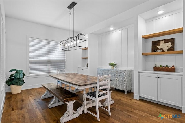 dining area featuring built in features and dark hardwood / wood-style floors