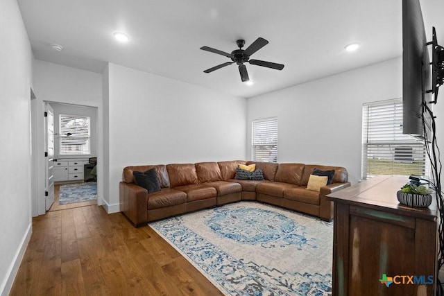 living room featuring a healthy amount of sunlight, hardwood / wood-style floors, and ceiling fan