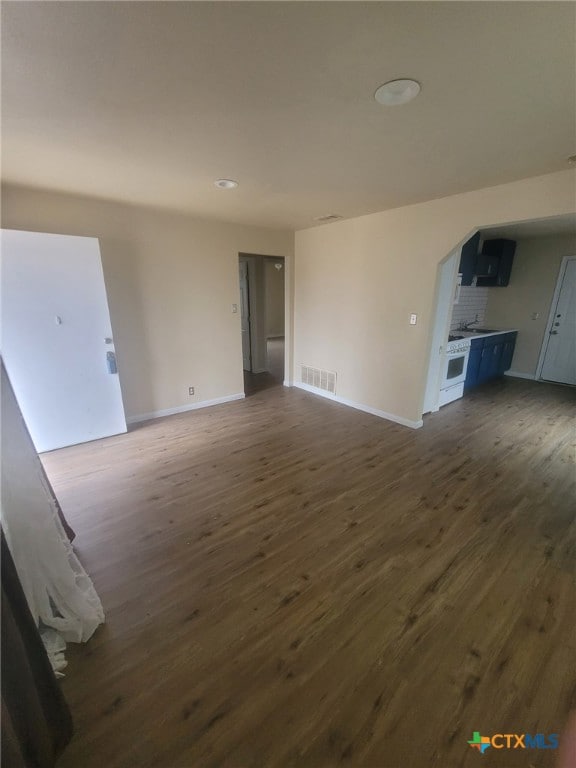 unfurnished living room featuring dark hardwood / wood-style floors