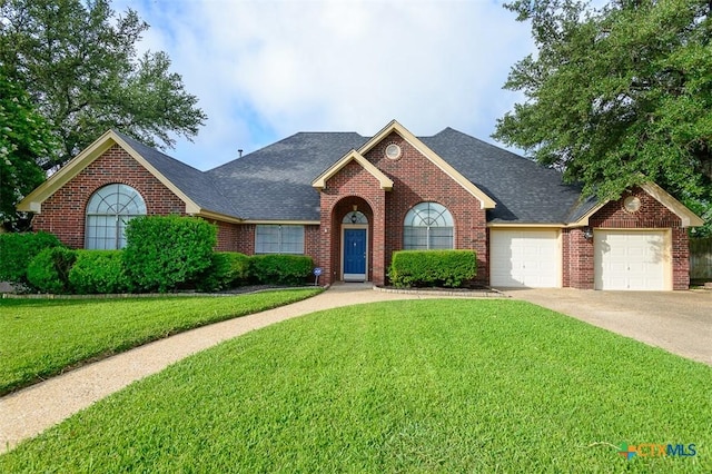 512 Gazelle Trl, Harker Heights, TX 76548 - traditional-style home featuring brick siding, an attached garage, a front yard, and a shingled roof