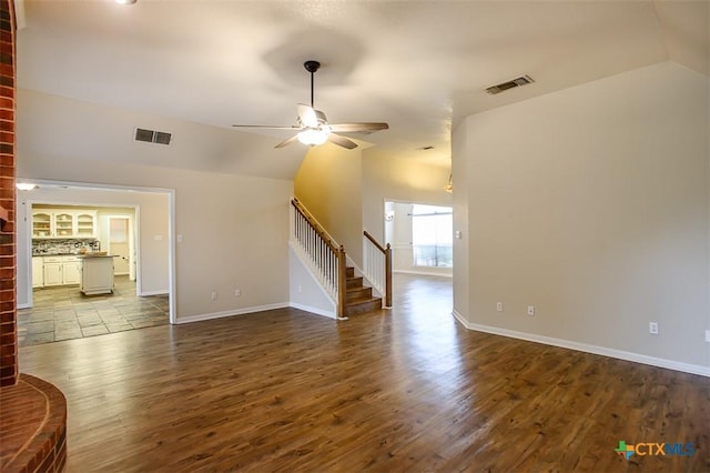 512 Gazelle Trl, Harker Heights, TX 76548 - unfurnished living room featuring vaulted ceiling, stairs, dark wood-type flooring, and a ceiling fan