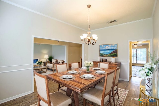 512 Gazelle Trl, Harker Heights, TX 76548 - dining area with wood finished floors, a chandelier, and crown molding