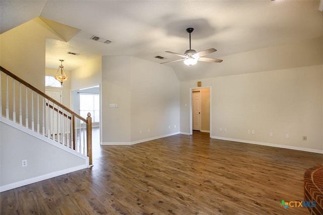 512 Gazelle Trl, Harker Heights, TX 76548 - unfurnished living room with dark wood finished floors, a ceiling fan, lofted ceiling, stairway, and a chandelier