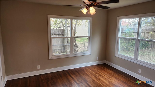 unfurnished room featuring ceiling fan, a healthy amount of sunlight, and dark hardwood / wood-style floors