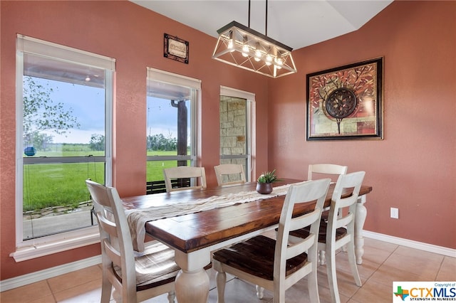 dining area with an inviting chandelier and light tile patterned floors