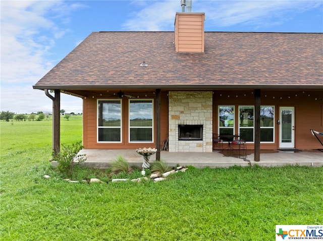 rear view of house featuring a patio area and a lawn