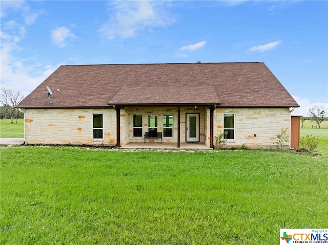 back of house featuring a yard and a patio area