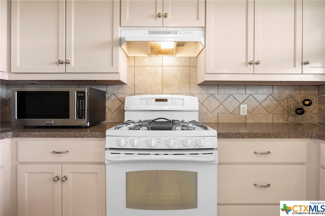 kitchen with white cabinetry, backsplash, and white gas stove