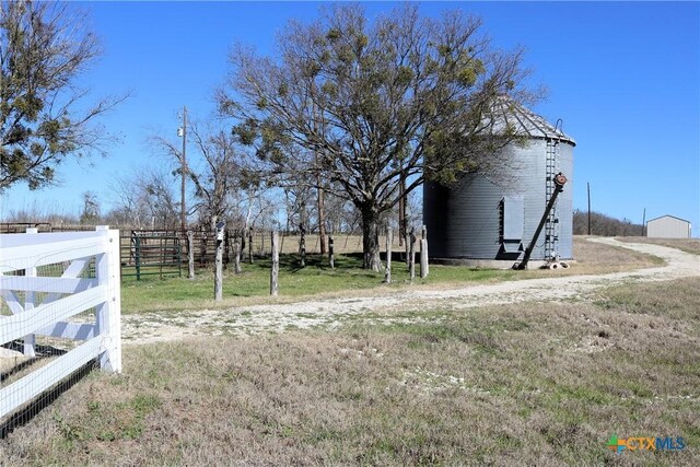 exterior space with an outdoor structure and a rural view