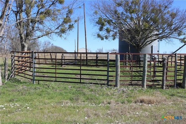 view of gate with a rural view