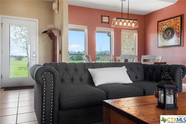 living room featuring light tile patterned flooring and a healthy amount of sunlight