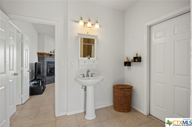 bathroom featuring tile patterned flooring and a tiled fireplace