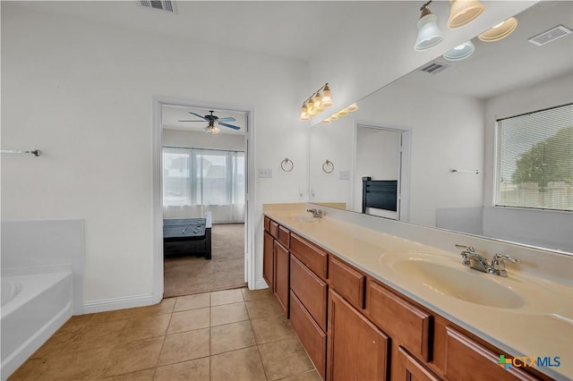 ensuite bathroom featuring ceiling fan, visible vents, and a sink