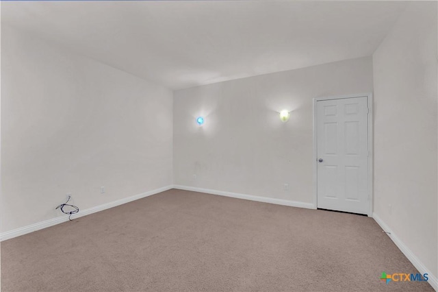 unfurnished room featuring baseboards and carpet floors