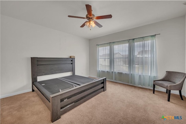 bedroom with a ceiling fan, baseboards, and carpet floors