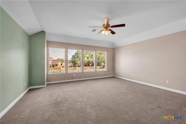 carpeted empty room with a ceiling fan, visible vents, and baseboards