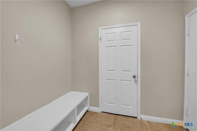 mudroom with light tile patterned floors and baseboards