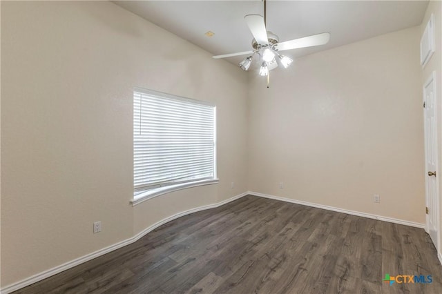 empty room with a ceiling fan, baseboards, and dark wood-type flooring