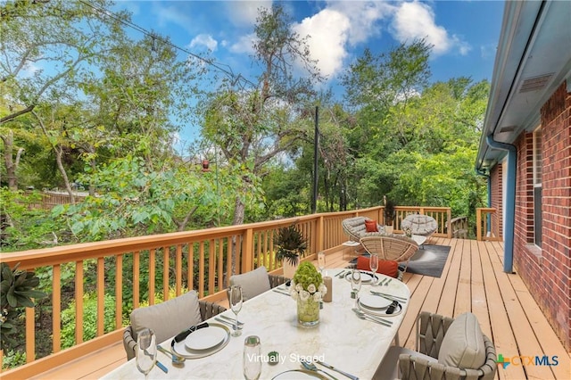 wooden terrace with outdoor dining area