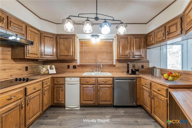 kitchen with brown cabinets, stainless steel dishwasher, a sink, and under cabinet range hood