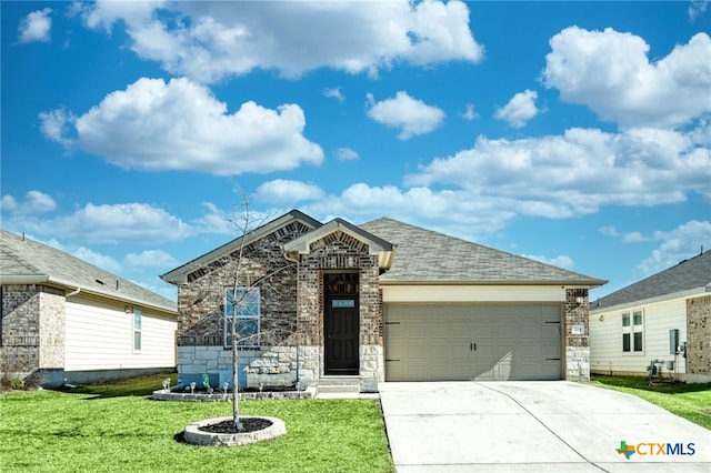 view of front of property with a front yard and a garage