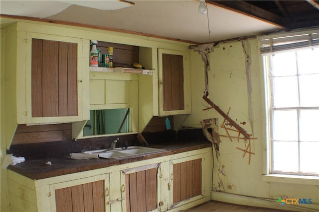 kitchen with dark countertops and a sink