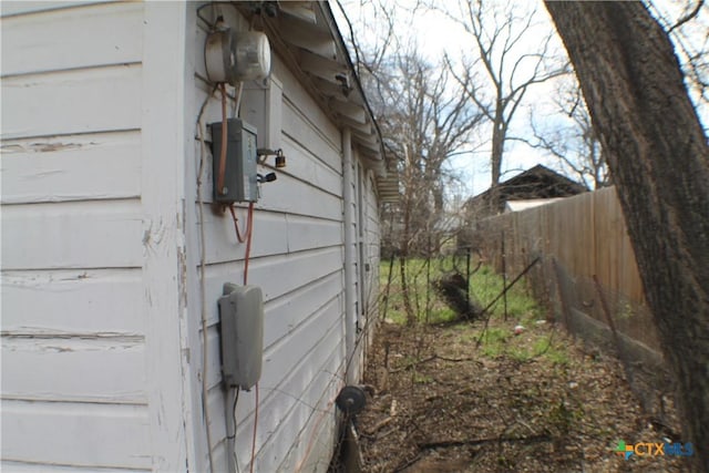 details featuring electric meter and fence