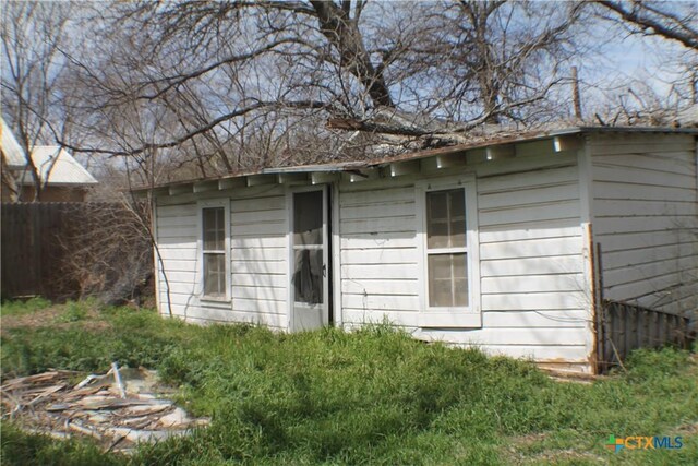 view of outbuilding with an outdoor structure and fence