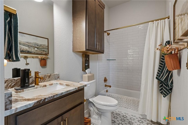bathroom featuring vanity, shower / bath combo, and toilet