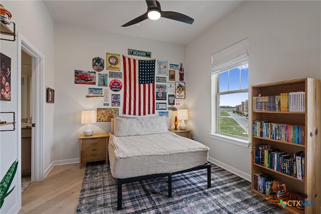 bedroom with baseboards, ceiling fan, and wood finished floors