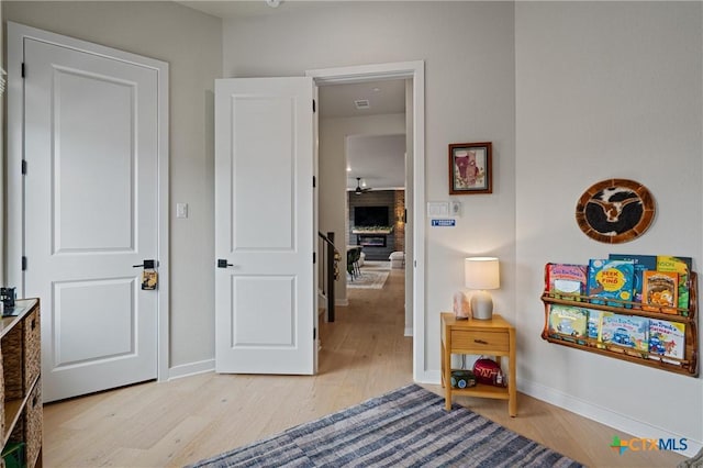 bedroom featuring light wood-style floors, baseboards, and visible vents