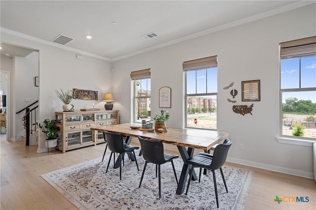 dining space featuring light wood-style floors, ornamental molding, recessed lighting, and visible vents