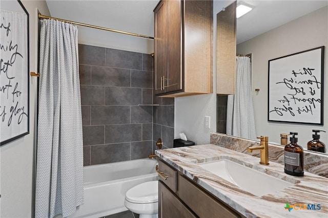 full bath featuring vanity, shower / bath combo with shower curtain, and toilet