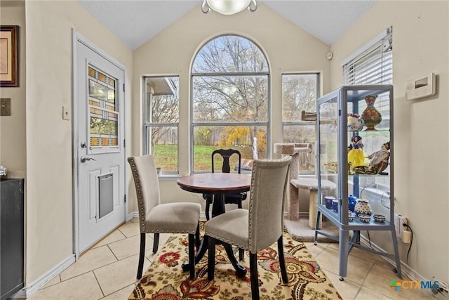 tiled dining space with lofted ceiling