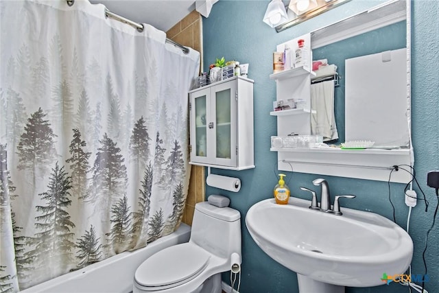 full bathroom with sink, shower / tub combo with curtain, and toilet