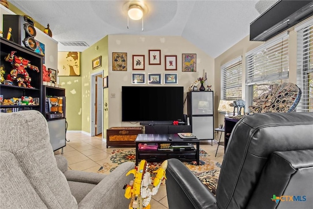 tiled living room featuring vaulted ceiling and ceiling fan