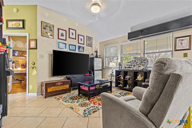 tiled living room with vaulted ceiling and ceiling fan