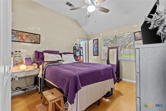 bedroom with ceiling fan, vaulted ceiling, and light wood-type flooring