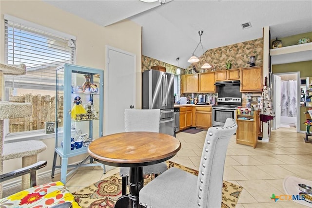 dining room featuring light tile patterned floors and lofted ceiling