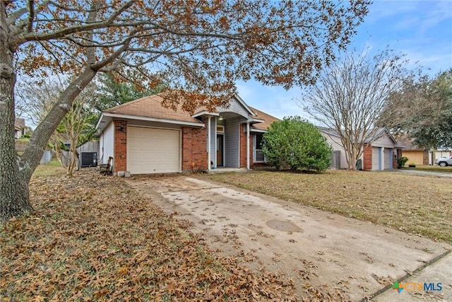 view of front of property with a front yard, a garage, and central air condition unit