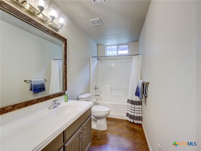 full bathroom featuring tile patterned floors, vanity, a textured ceiling, shower / tub combo, and toilet