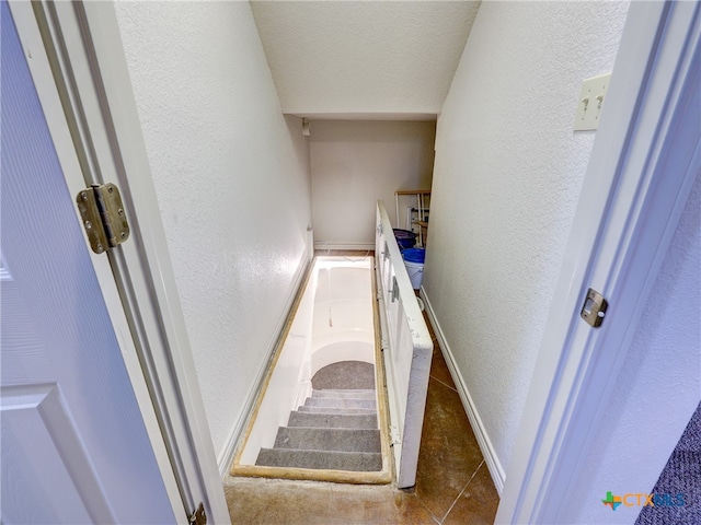 staircase featuring tile patterned flooring