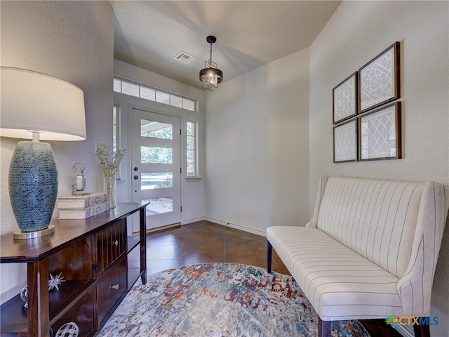 tiled foyer with a textured ceiling