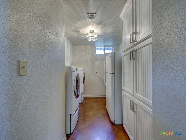 laundry area featuring a textured ceiling and separate washer and dryer