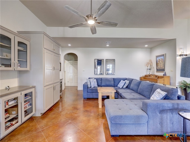 tiled living room featuring a textured ceiling and ceiling fan