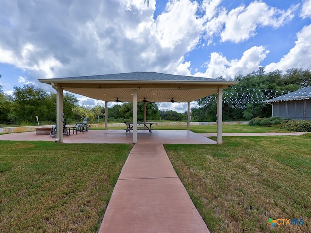 surrounding community with a yard and a patio area