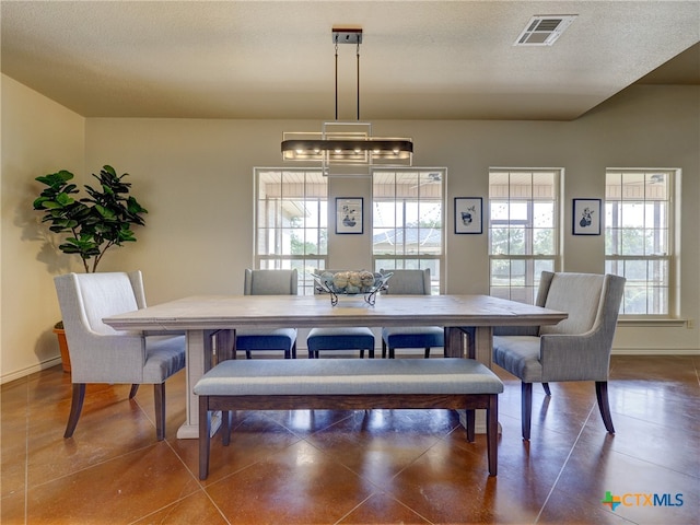 dining area featuring a textured ceiling